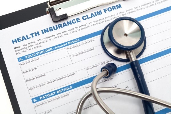 Health insurance claim form with stethoscope on top