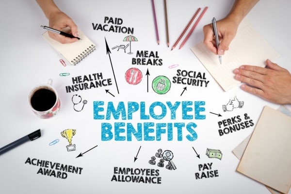 Close-up of hands taking notes about employee benefits