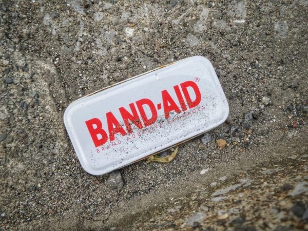 Band-aid container on ground