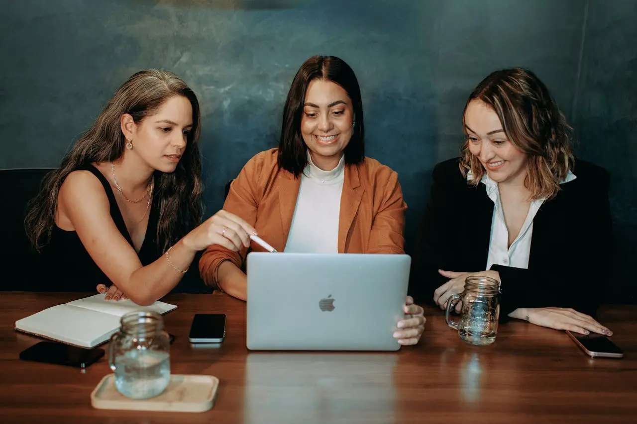 Team reviewing health insurance alternatives on a laptop during a benefits planning meeting