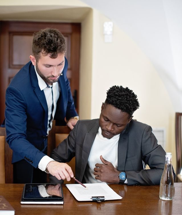 Insurance advisor reviewing policy documents with a client at a desk, discussing Texas Health Savings Account Plans options
