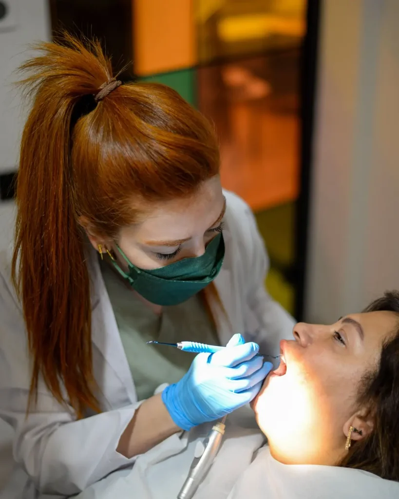 Dentist working on a patient, a reminder to check your dentist is in network before picking the best dental insurance in Texas