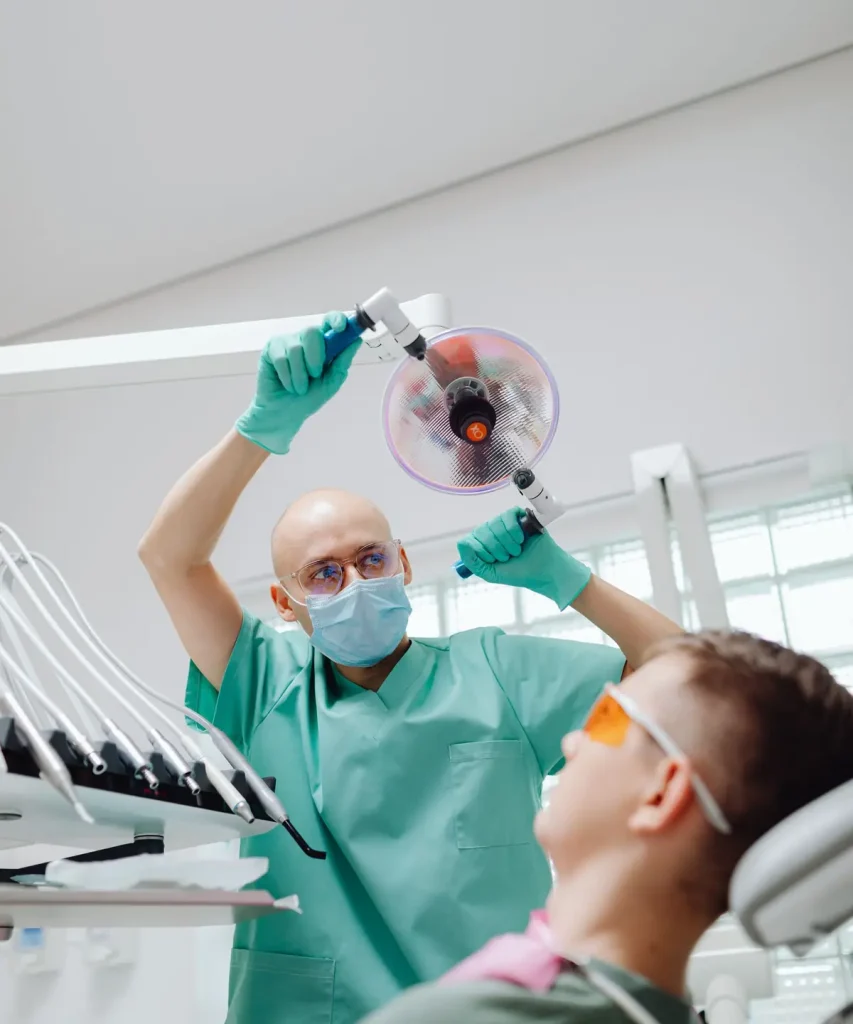 Dentist preparing to treat a patient, where the DPPO or DHMO network behind the best dental insurance in Texas decides your cost