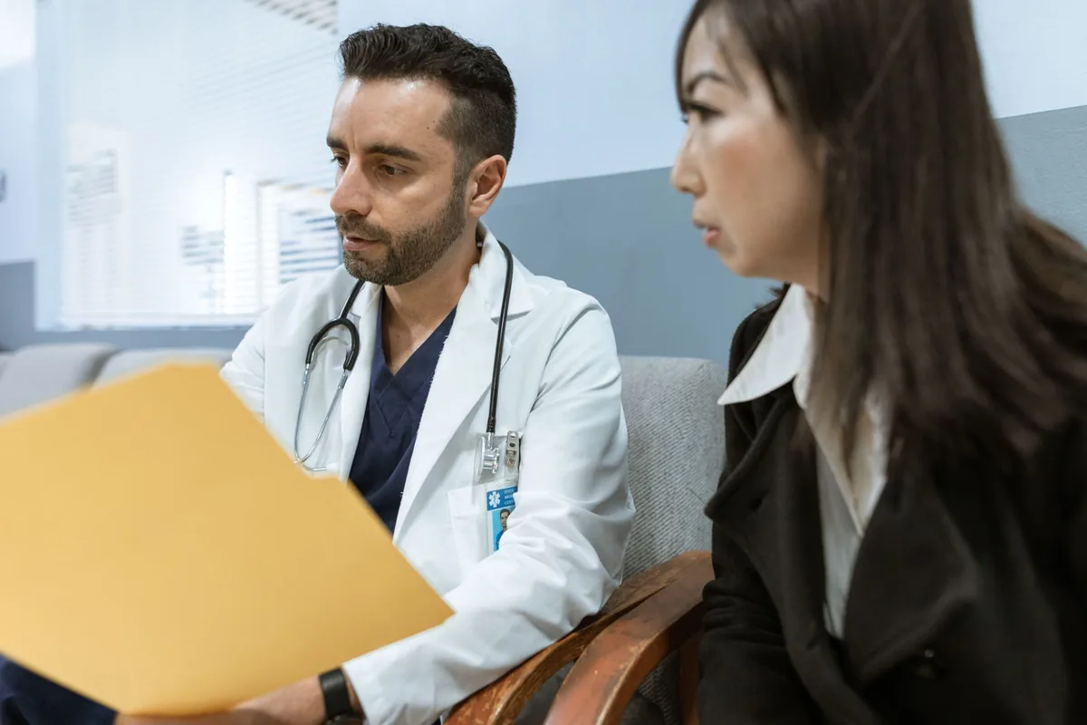 Doctor consulting a patient covered by a Blue Cross Blue Shield Texas PPO or HMO plan