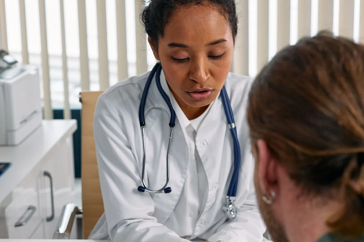 Reviewing Blue Cross Blue Shield Texas PPO and HMO network options with a physician