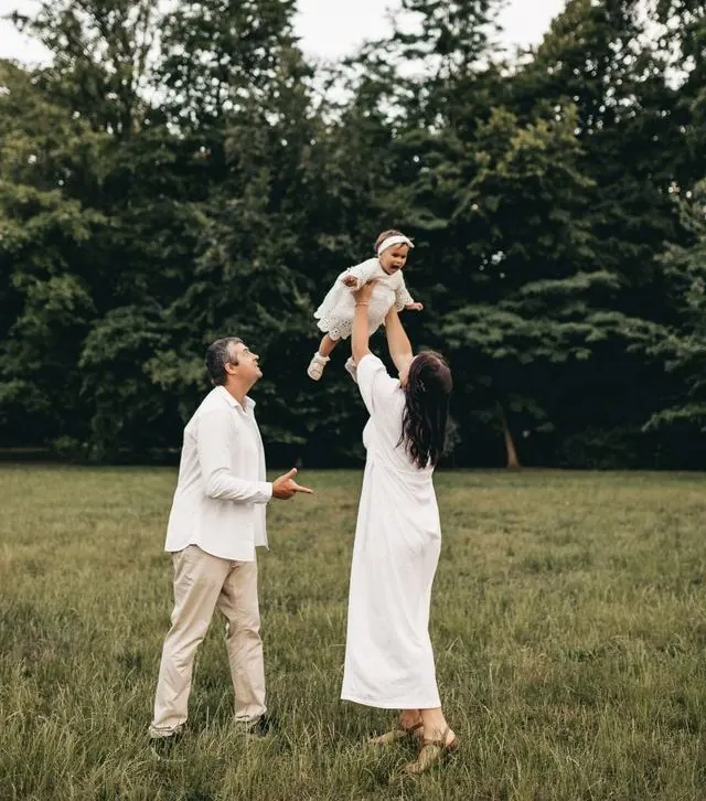 Family health insurance in Texas discussed by parents outdoors with their child