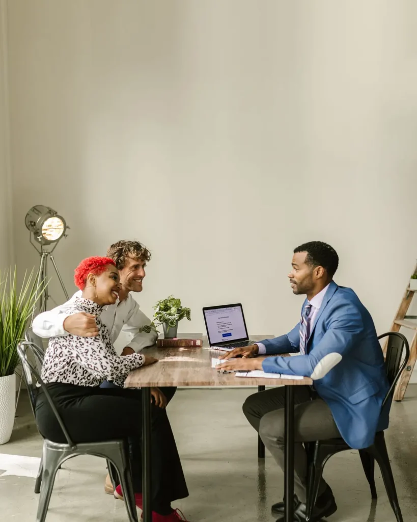 Couple meeting a broker to see how fixed indemnity health insurance covers the gap left by a high deductible