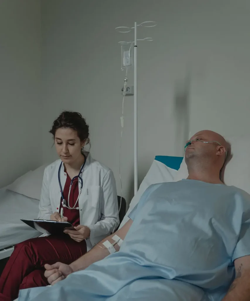 Doctor reviewing notes with an older patient, showing why fixed indemnity health insurance has a 12 month pre-existing waiting period
