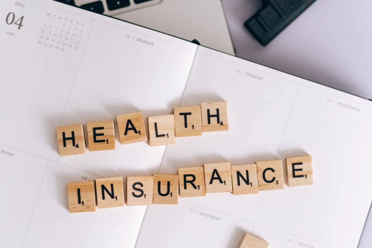 Health insurance spelled on a calendar, marking when to enroll in an HSA insurance plan in Texas
