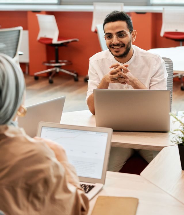 Small business owner reviewing health insurance plan options in Texas office meeting