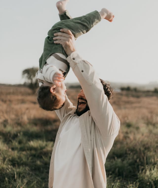 Father and child bonding outdoors, supported by family health insurance in Texas