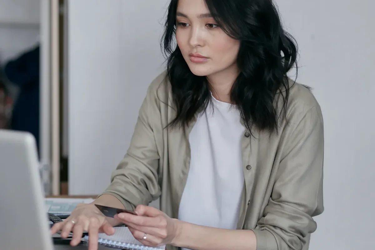 Person at a laptop with paperwork, keeping track of every health insurance deadline that matters in Texas