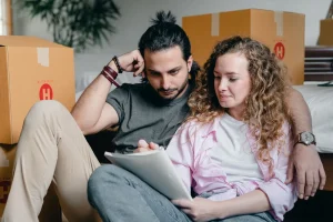 Couple among moving boxes reading papers to see if they qualify for special enrollment period health insurance in Texas