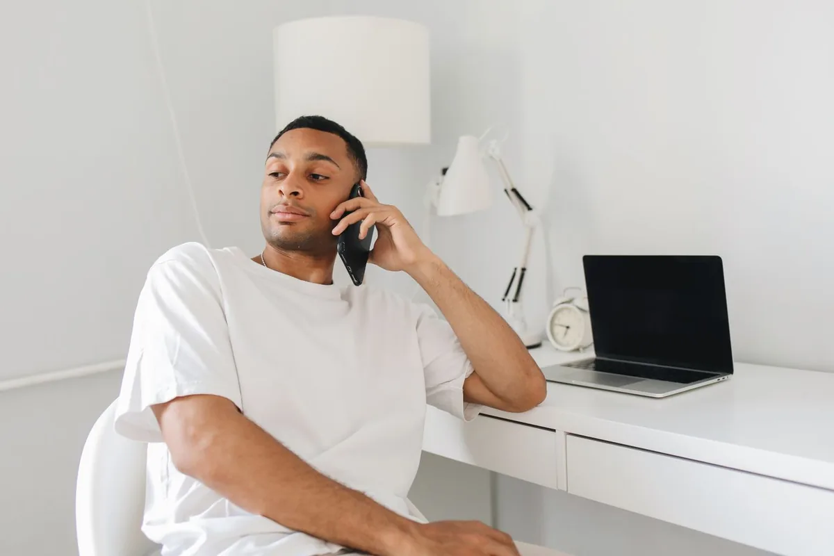 Man calling the Marketplace to set an end date, showing how to cancel when you ask can I cancel my health insurance during open enrollment