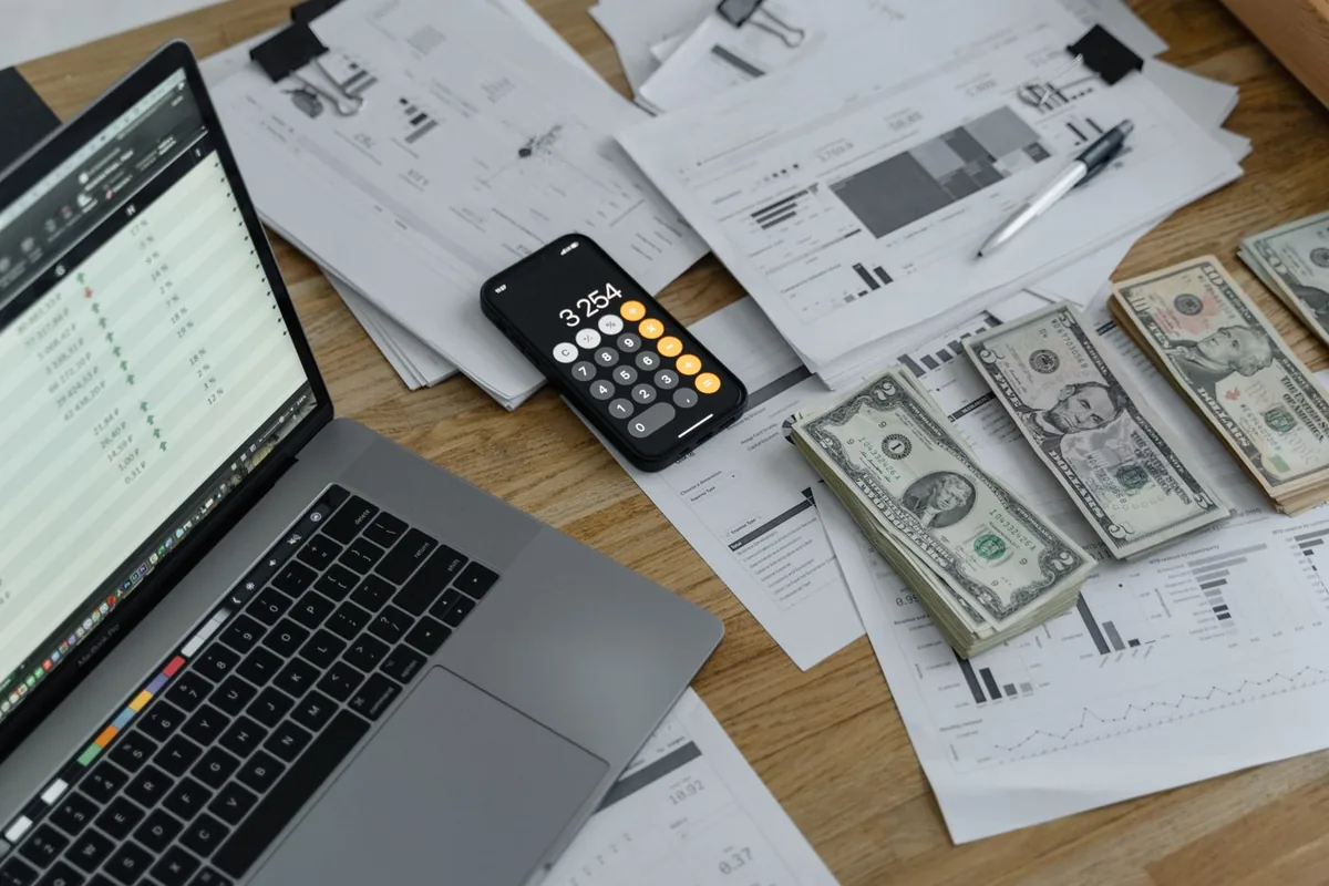 can i change my health insurance plan after enrollment: bills, calculator and laptop used to weigh deductible progress against premium savings