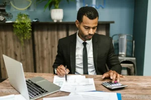 can i change my health insurance plan after enrollment: a Texas policyholder comparing plan paperwork with a calculator and laptop