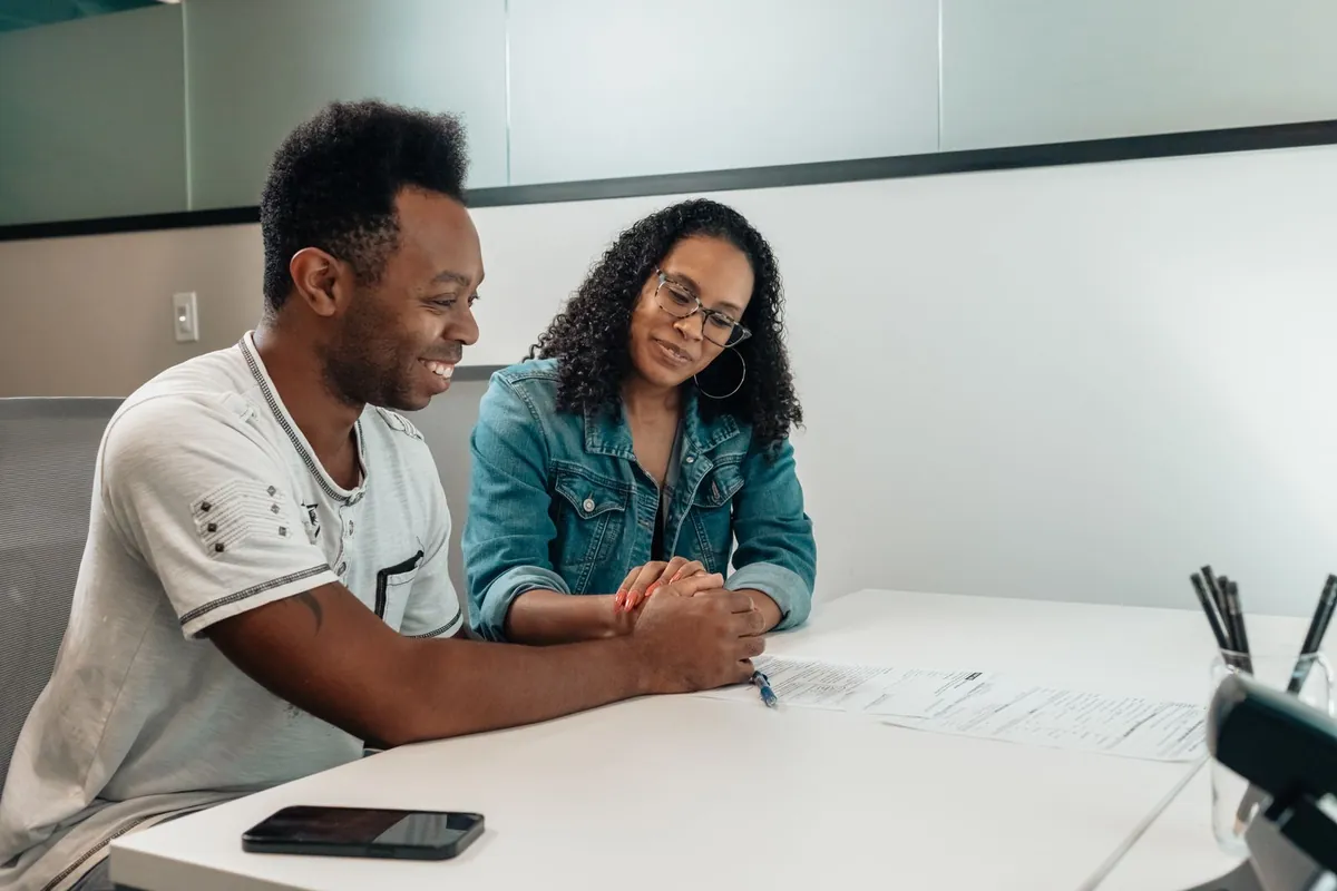 Couple reviewing paperwork together while deciding how to get health insurance outside of open enrollment or wait