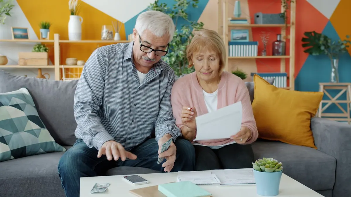Older couple comparing plan costs to answer is health insurance cheaper during open enrollment or with a private plan