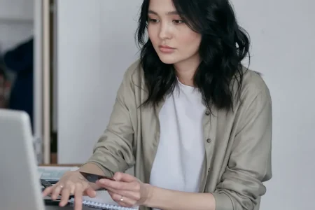 Person at a laptop with paperwork, keeping track of every health insurance deadline that matters in Texas