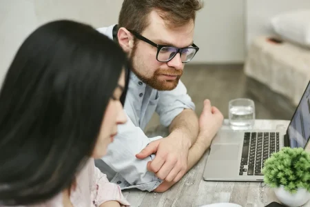 Texas couple comparing an HSA insurance plan against other options on a laptop