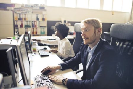 Professional reviewing health coverage options online to avoid a lapse in health insurance between jobs penalty