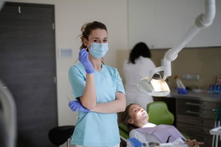 Dentist in Texas explaining COBRA alternative health insurance options to a patient during consultation