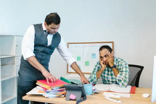 Stressed small business owner reviewing paperwork while searching for affordable health insurance for small business options