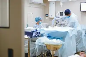 Surgical team performing a procedure in an operating room, illustrating health insurance before Medicare coverage needs.