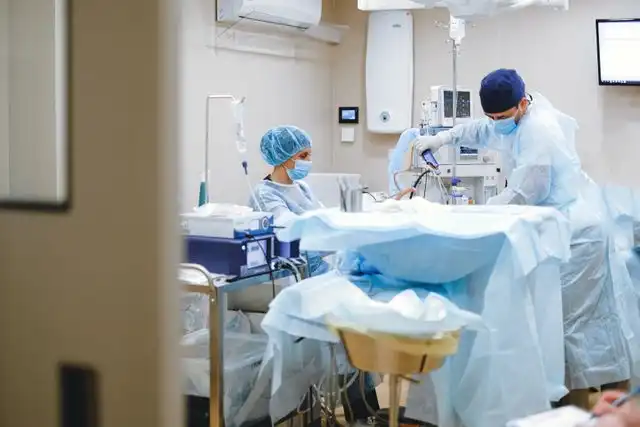 Surgical team performing a procedure in an operating room, illustrating health insurance before Medicare coverage needs.